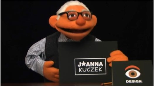 A photo of a poppet portraying an old man with a card that says J Star Anna Kuczek.