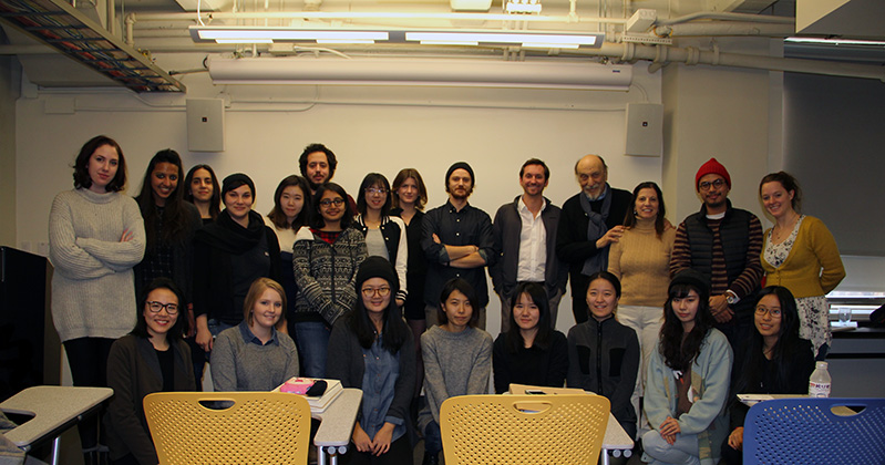 A photo of a group of peoples in a classroom.