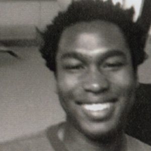A photo of a man smiling.
