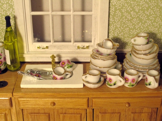 A photo of a kitchen table with porcelain pots and glasses on it.
