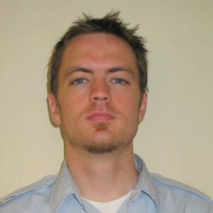 A photo of a man wearing a blue shirt.