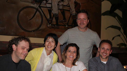 A photo of a group of people sitting at a table.