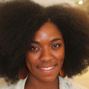A photo of a woman wearing a white and blue shirt.