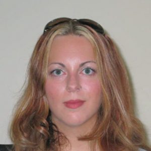 A photo of a woman wearing sunglasses on her head.