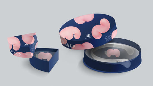 An image of a round blue box printed with pink Styrofoam like pieces which contains a pink usb drive and a white collar headphone. Also there is another box but with a fourth of a size as the original which contains only a pink usb drive.