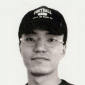 A photo of a man wearing a football cap and glasses.