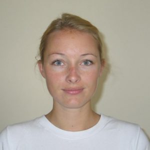 A photo of a woman wearing a white shirt.