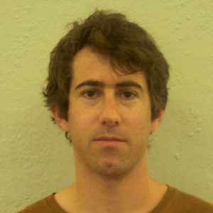 A photo of a man wearing a brown t-shirt.