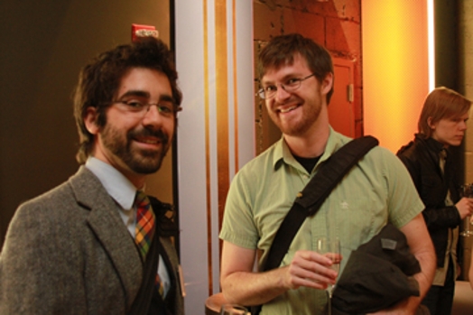 A photo of two people with champagne glasses in their hands.