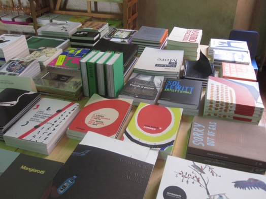 A photo of a desk filled with books.