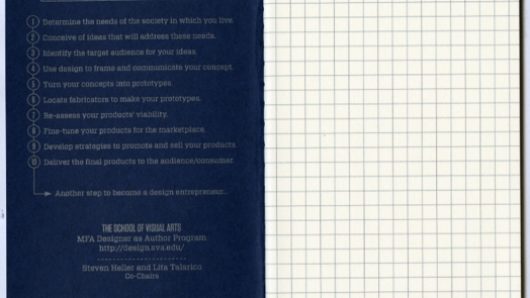 A blue notebook with text on a side and squares on the other.