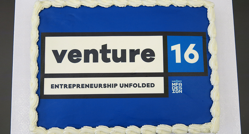 A blue and white cake with the logo of Venture 16 Entrepreneurship Unfolded. NYC SVA MFA Design.