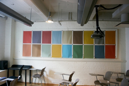 A classroom that has multicolored squares on the wall.