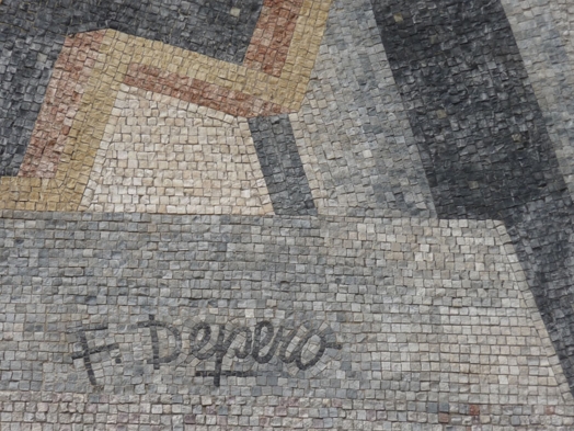 A stone mosaic with some letters.