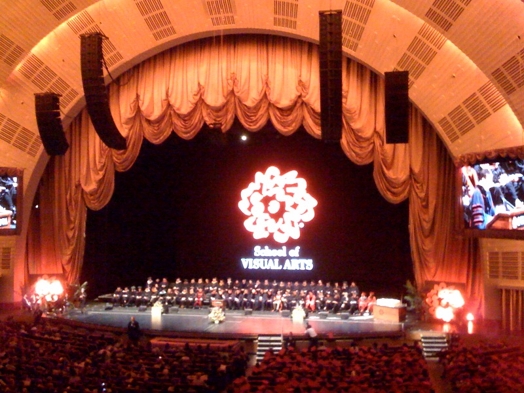 A semicircled stage with a bright red SVA logo.