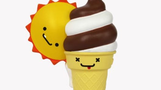 A photo of some toys depicting a personified sun and chocolate ice cream, one melting the other.