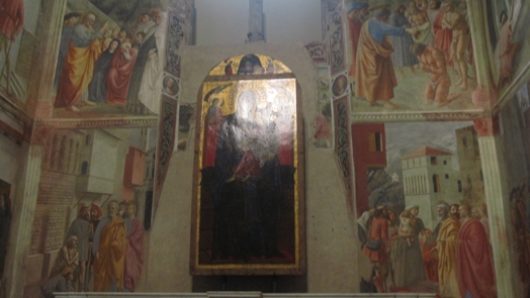 A photo of some frescos depicting different events.