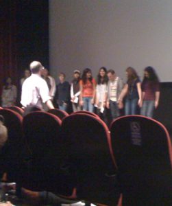A group of people standing inline on the stage.