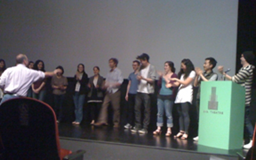 A group of people applauding on the stage.