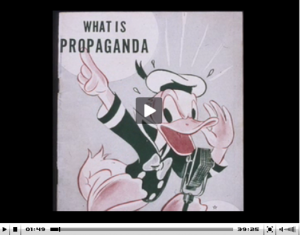An old cartoon of Donald Duck shouting at a microphone: What is propaganda.