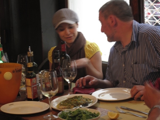 A photo of two people at a table in a restaurant.