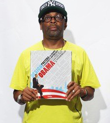 Spike Lee holding a book about Obama