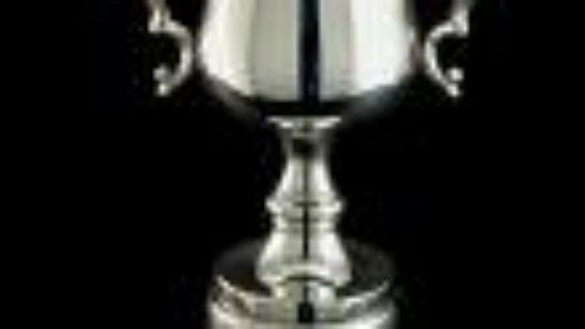 A silver cup on a black background.