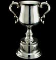 A silver cup on a black background.