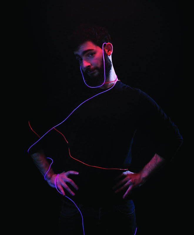 A man with glowing blue and red wires around.