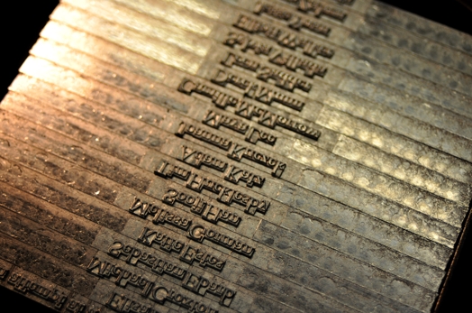 A stack of iron letters used for a printing press.