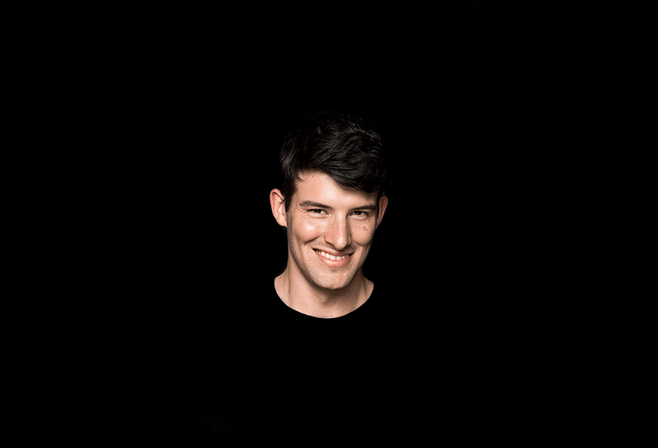 portrait of a young man on a pitch-black background