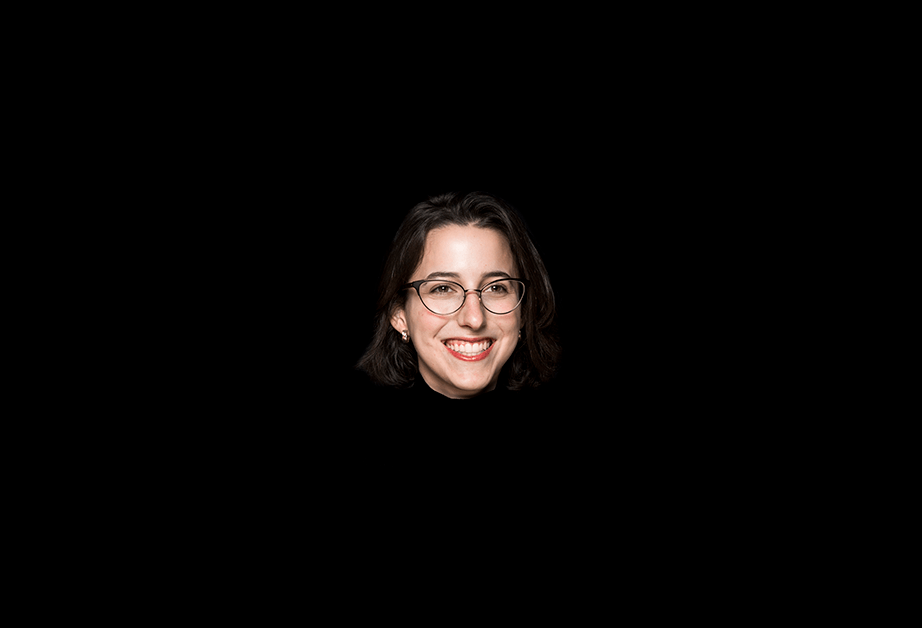 A photo of a smiling woman wearing glasses and a black blouse.