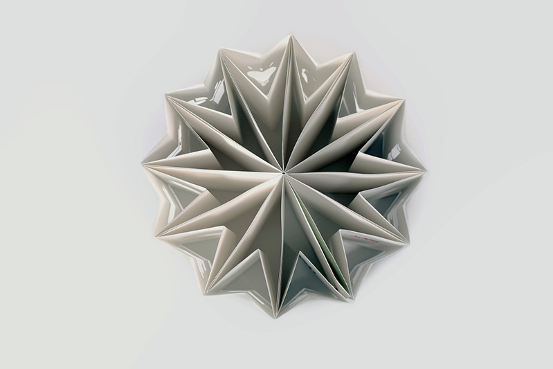 A 3d star shape made from paper and seen from above.