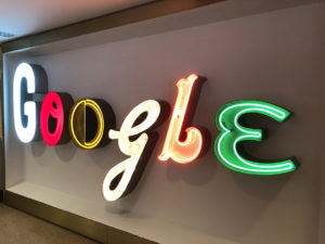 the word google is written with neon sign letters in blue, red, yellow, orange, and green