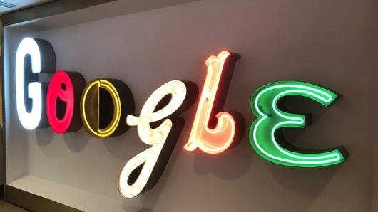 the word google is written with neon sign letters in blue, red, yellow, orange, and green