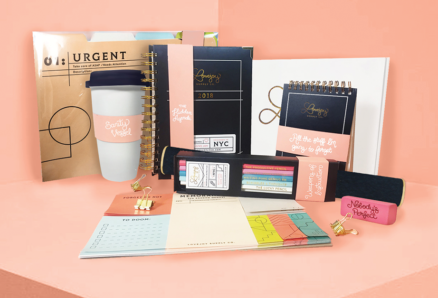 A photo showing coffee cups, notebooks, color pencil boxes, rubbers, stickers, calendars and other office items with some text logo on them.