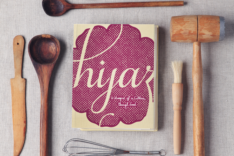 hijaz book surrounded by wooden kitchen tools