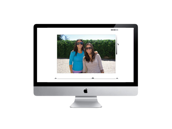 a portrait of two women is displayed on an iMac screen