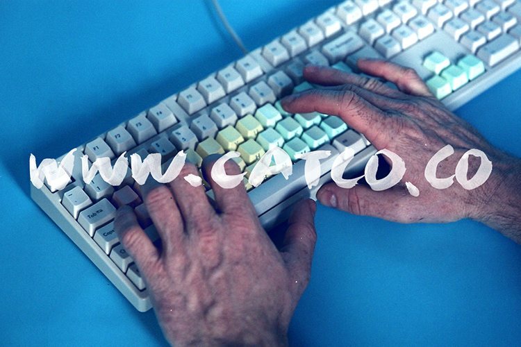 www.catco.co written over an image of two hands typing on an white computer keyboard