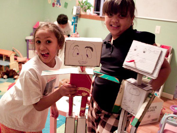 portrait of two young girls with cardboard-made characters