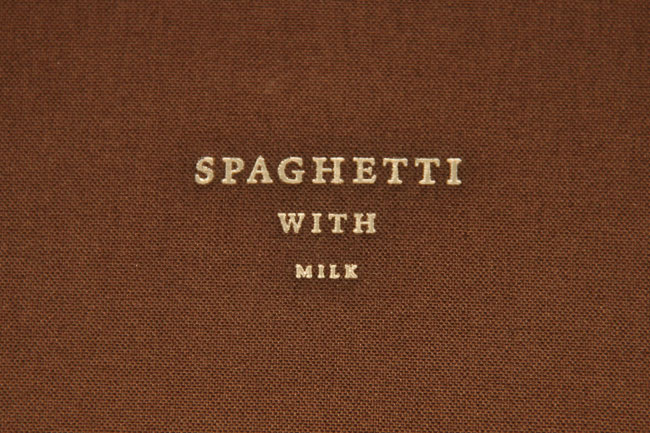 close-up of the brown cover with the title Spaghetti with milk