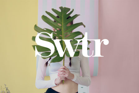 swtr logo over a portrait of a woman holding a large leaf over her upper body