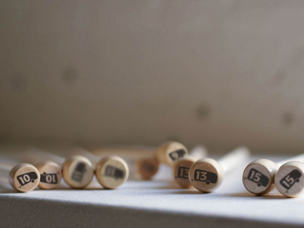 small recipient caps made of wood with numbers on them