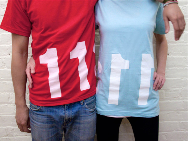 two people, one wearing a red t-shirt with 11 and the other one wearing a baby blue t-shirt with 11
