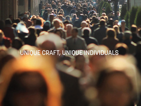 unique craft, unique individuals typography on an image of many people walking on the sidewalk