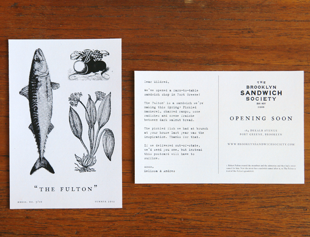 a postcard with illustrations of a fish and two plans on the front side and a text and the brooklyn sandwich society logo on the back