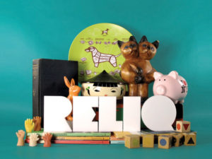 reliq logo surrounded by figurines and sculptures