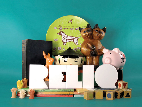 reliq logo surrounded by figurines and sculptures