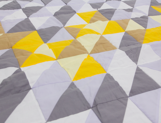 a fabric with triangular pattern in grey and yellow