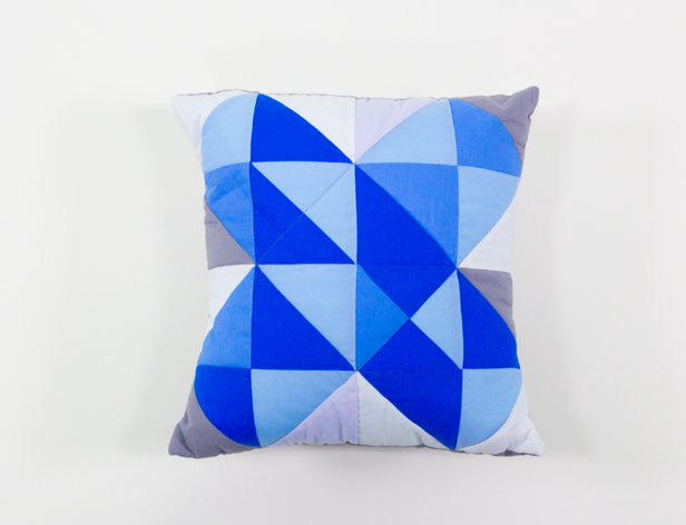 a small cushion with an angular blue pattern